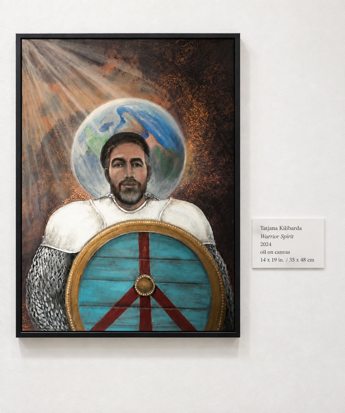 Warrior Spirit displayed on a gallery wall beside its exhibition label.