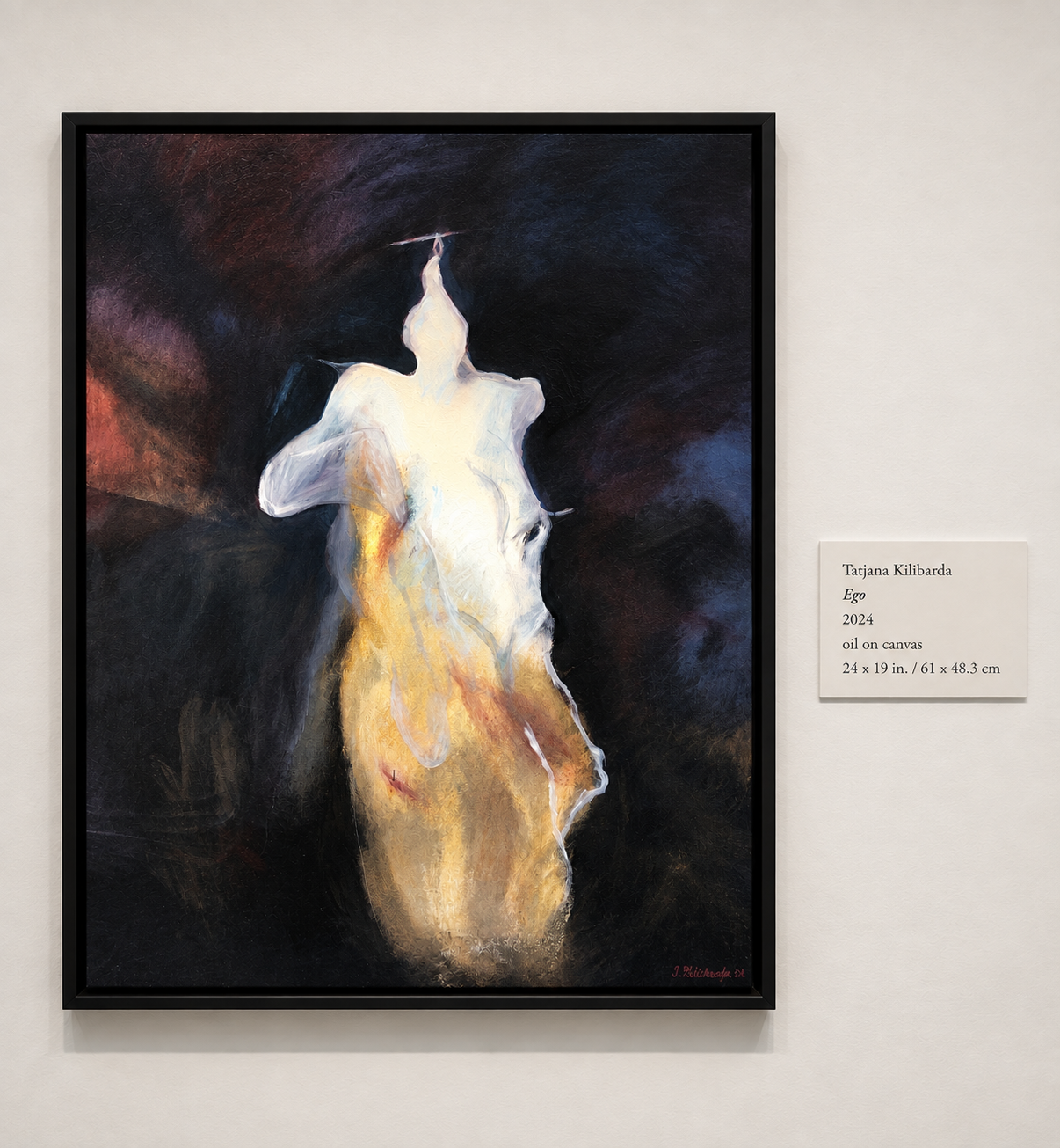 Ego displayed on a gallery wall beside its exhibition label.